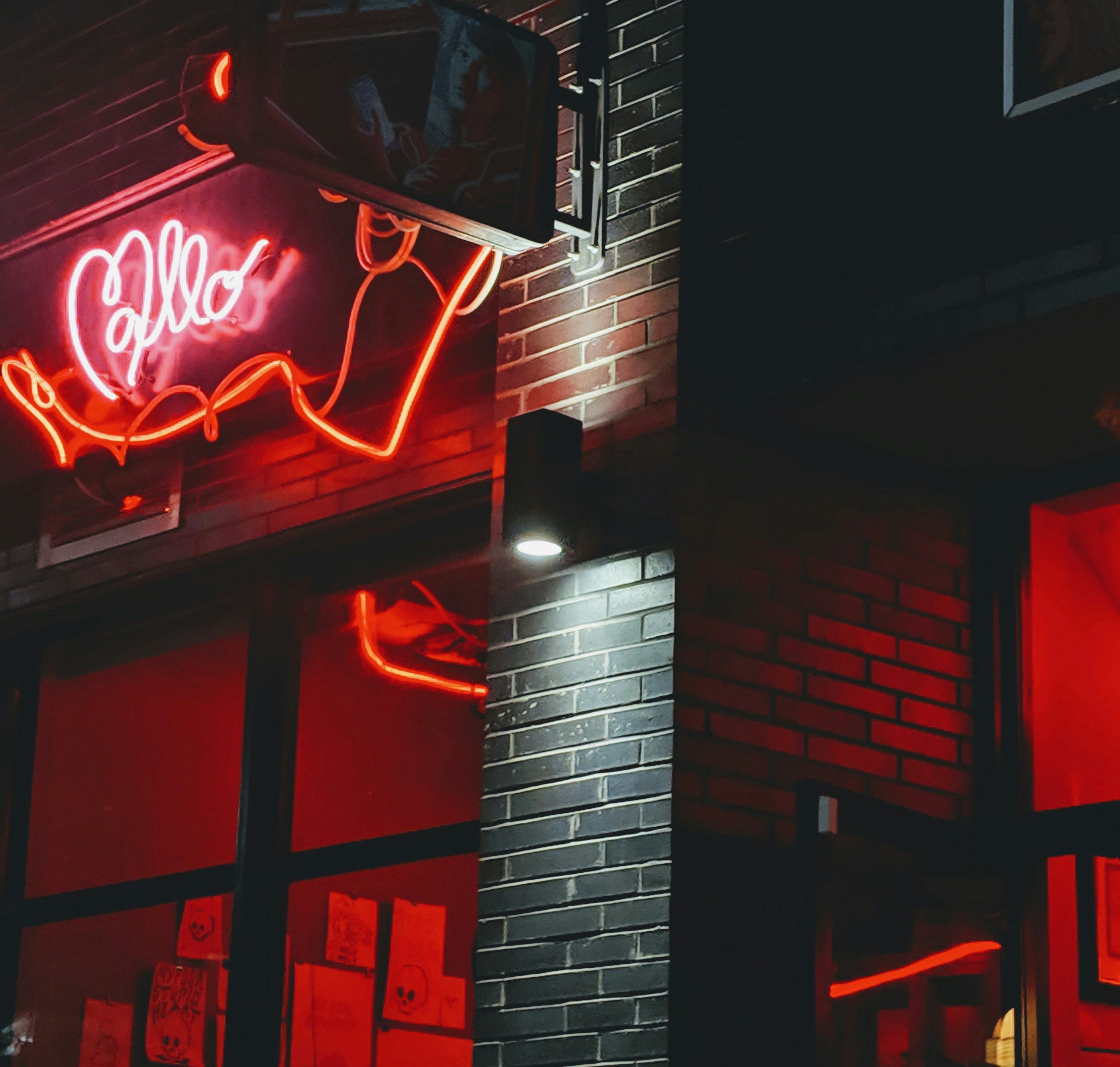 Néon rouge sur briques d'un club parisien la nuit